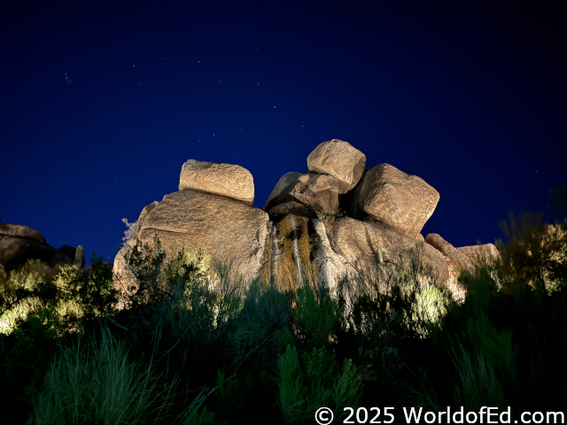 Stacked boulders with stars showing above them.